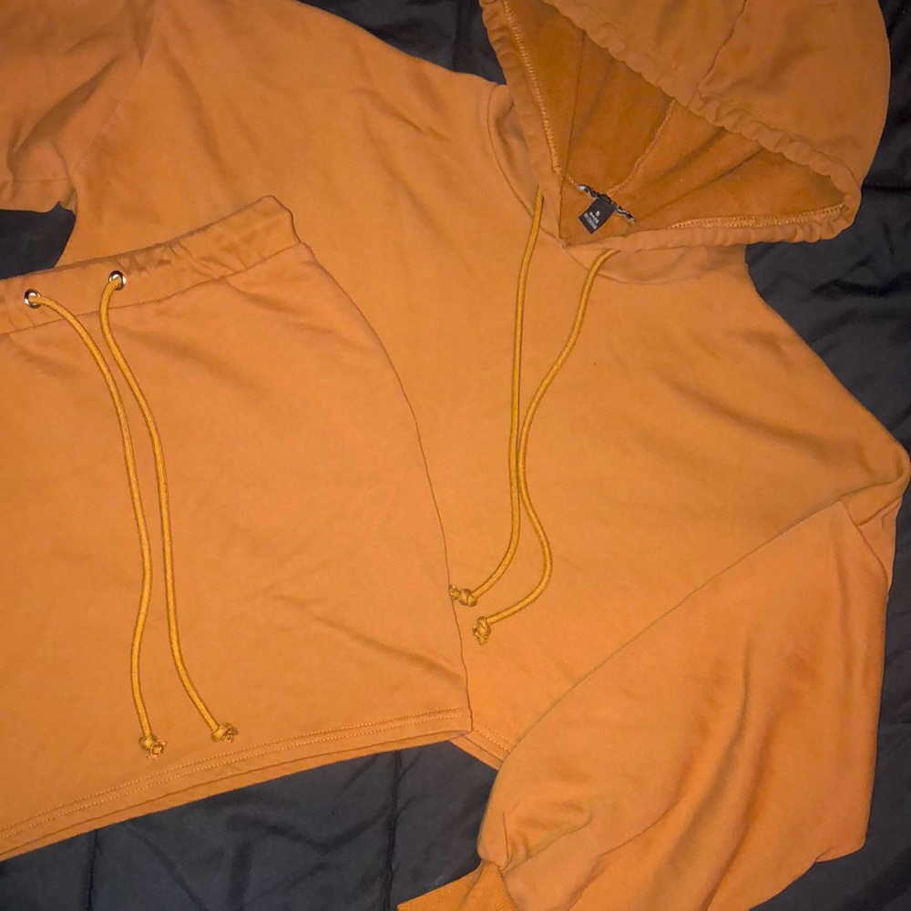 Tan crop hoodie with princess sleeve mini skirt set.
